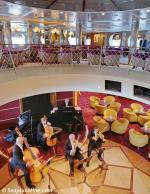 ID 2952 MILLENNIUM (2000/90288grt/IMO 9189419. Renamed CELEBRITY MILLENNIUM in 2009) - A string quartet with piano accompaniment play in the foyer of the Rendezvous Lounge on Promenade Deck. Upper level is...